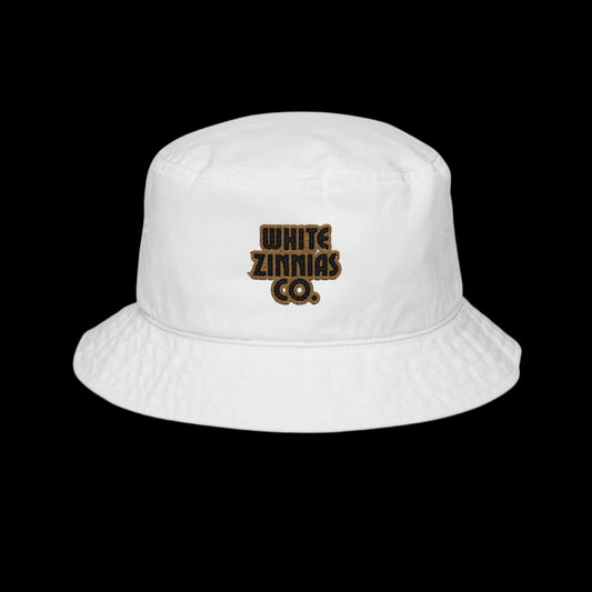 White bucket hat with 'White Zinnias Co.' logo on a white background