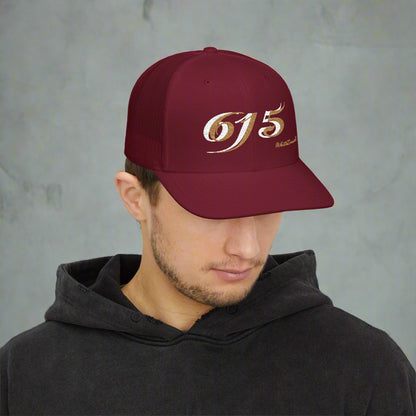 Man wearing a maroon cap with '615' logo on a white background